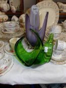 A purple studio glass vase and a green studio glass vase.