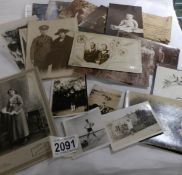 A quantity of black and white portrait photographs including some with postcard backs.