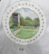 A hand painted Royal Crown Derby cabinet plate depicting Haddon Hall, singed W.E.J.