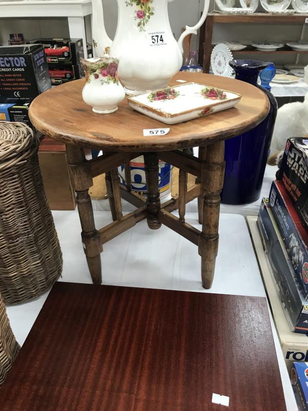 A dark wood small round stained coffee table