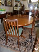 A G Plan extending dining table with 4 chairs.
