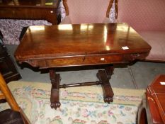 A Victorian rosewood fold over card table.