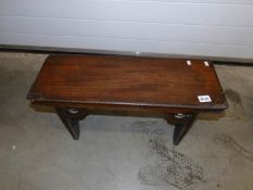 A Victorian mahogany long stool.