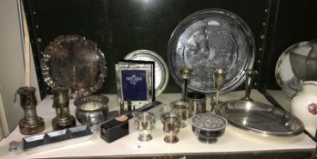 A shelf of plated ware including trays, miner's lamps etc.