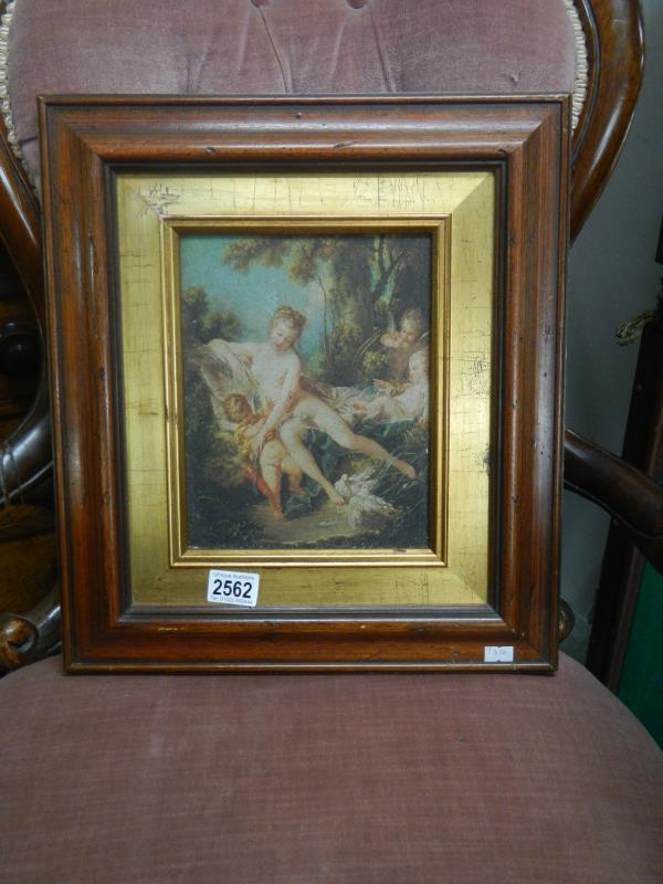 A framed print of a classical scene on board.