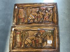 2 carved wooden plaques featuring Caribbean scenes