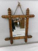 A small spindle framed mirror.