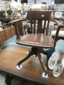 A 1920'/30's oak office swivel chair