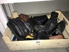 A box of camera lenses etc.