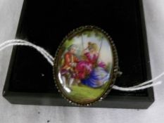 An early 20th century hand painted brooch.