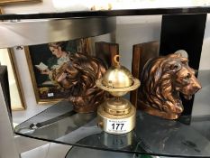 A pair of lion bookend and a globe table lighter