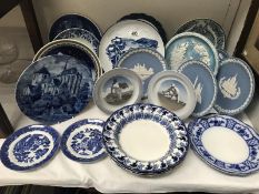 A quantity of blue and white plates including Royal Copenhagen, Delft, Wedgwood etc.