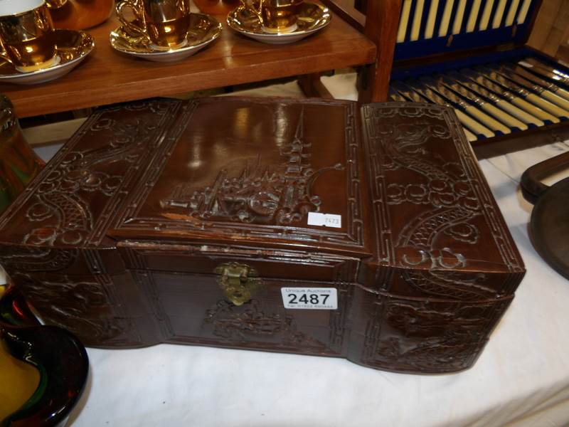 An oriental musical jewellery box and contents.