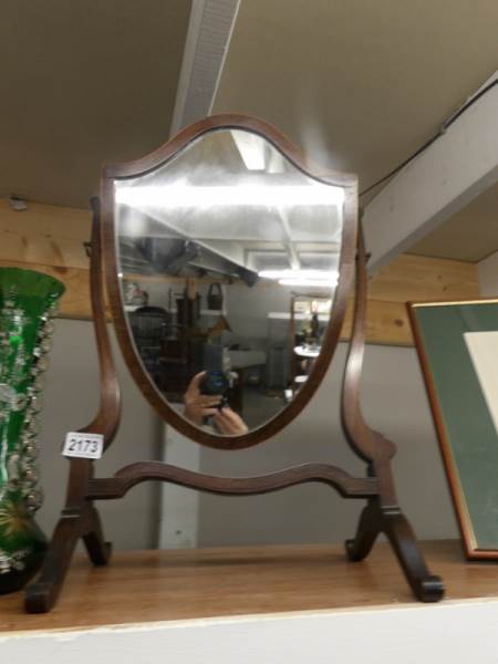 A mahogany shield shaped toilet mirror.