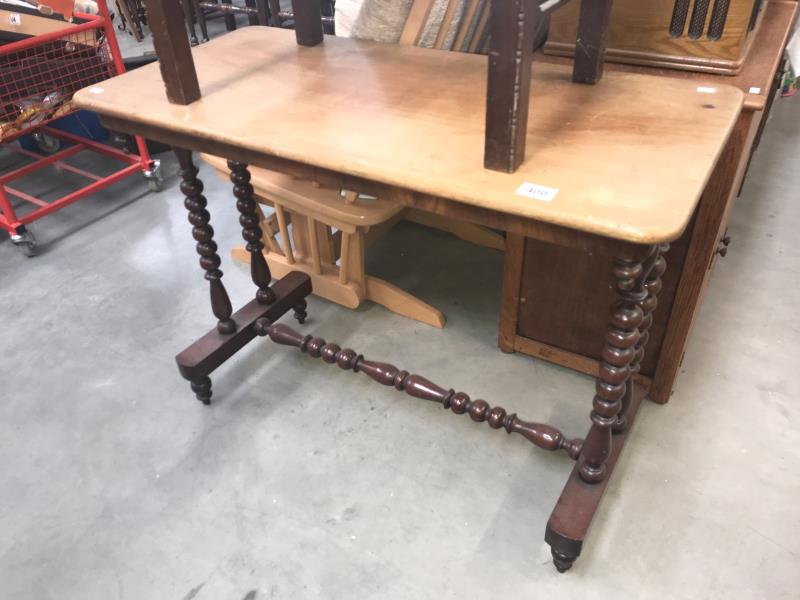 A Victorian mahogany side table with bobbin turned legs and cross stretcher