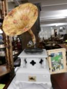 A reproduction horn gramaphone with painted case and floral decorated horn.