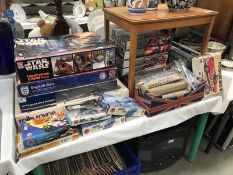 Over 20 model kits including some part-built featuring racing cars, Star Wars, wood kits, revel,