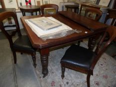 A Victorian wind out dining table with one leaf and a set of 4 Victorian dining chairs.