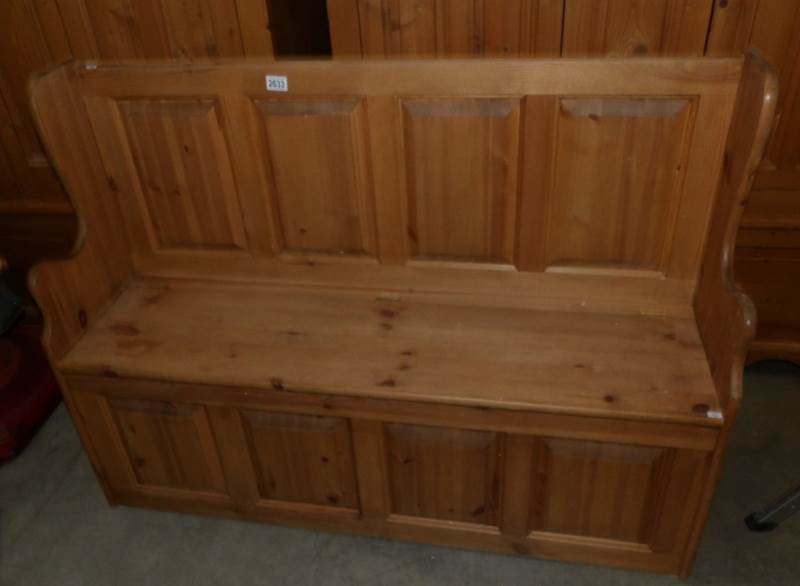 A pine settle with storage under seat.