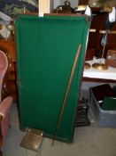 A small table top snooker table with accessories.