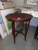 An oval mahogany pie crust edge occasional table.