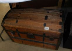 A wooden domed top trunk with inner tray.