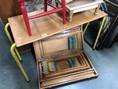 A picnic bench with stools and a vintage table