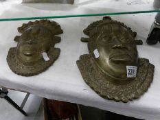 2 replica brass coloured bronze face wall plaques of Festac mask.