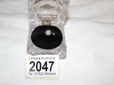 A diamond set cluster ring , gold set, size L.