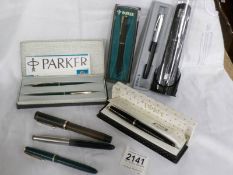 A collection of Parker fountain pens including some with 14ct gold nibs.