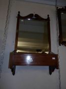 A mahogany framed wall mirror with bottom box.