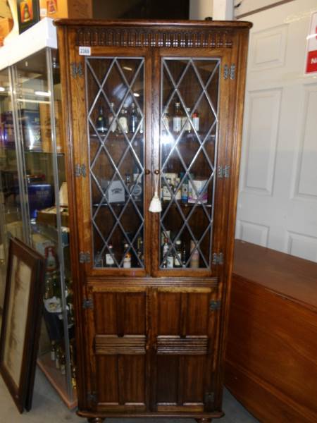A Priory style oak corner cabinet.