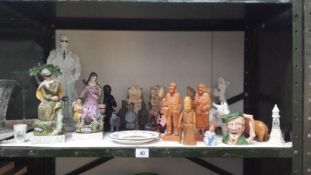 A collection of pottery and wooden figurines and plates including Staffordshire