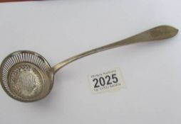 A Georgian silver sifter spoon (approximately 50 grams).