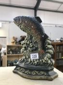 A cast iron door stop in the shape of a fish