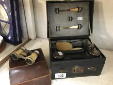 A Vanity case with contents, featuring silver topped bottles,