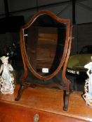 A shield shaped mahogany toilet mirror.