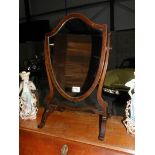 A shield shaped mahogany toilet mirror.