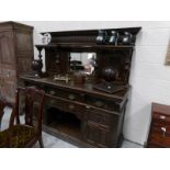 A Victorian carved oak mirror backed sideboard.