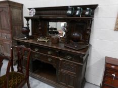 A Victorian carved oak mirror backed sideboard.