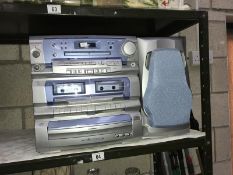 A Goodman's 3 disk twin cassette music system with 1 speaker.