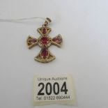 A 9ct gold cross pendant/brooch set red and white stones. (22 grams).
