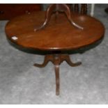 A oak tripod coffee table.