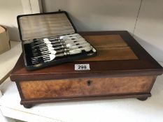 A case of 1930s, forks and a wooden box.