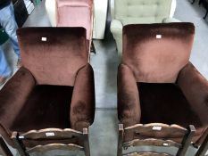A pair of brown suede effect arm chairs.