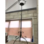 A wrought iron extending candle stand.