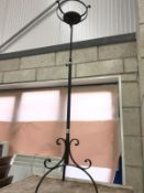 A wrought iron extending candle stand.