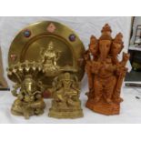 A heavy brass figure of Lord Ganesh, one other, another figure and a brass plaque.