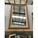 A gold painted pie crust framed mirror.