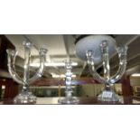 A pair of glass candelabra and a glass candlestick.